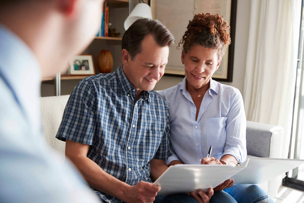 Senior couple meeting with male financial advisor.